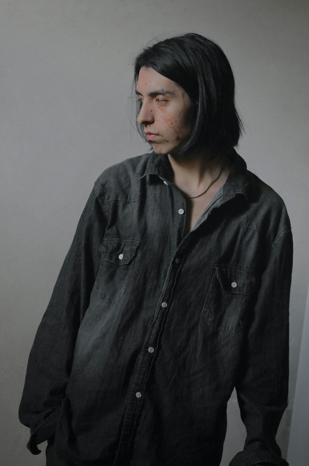 Studio portrait of a man with short dark hair in a shirt