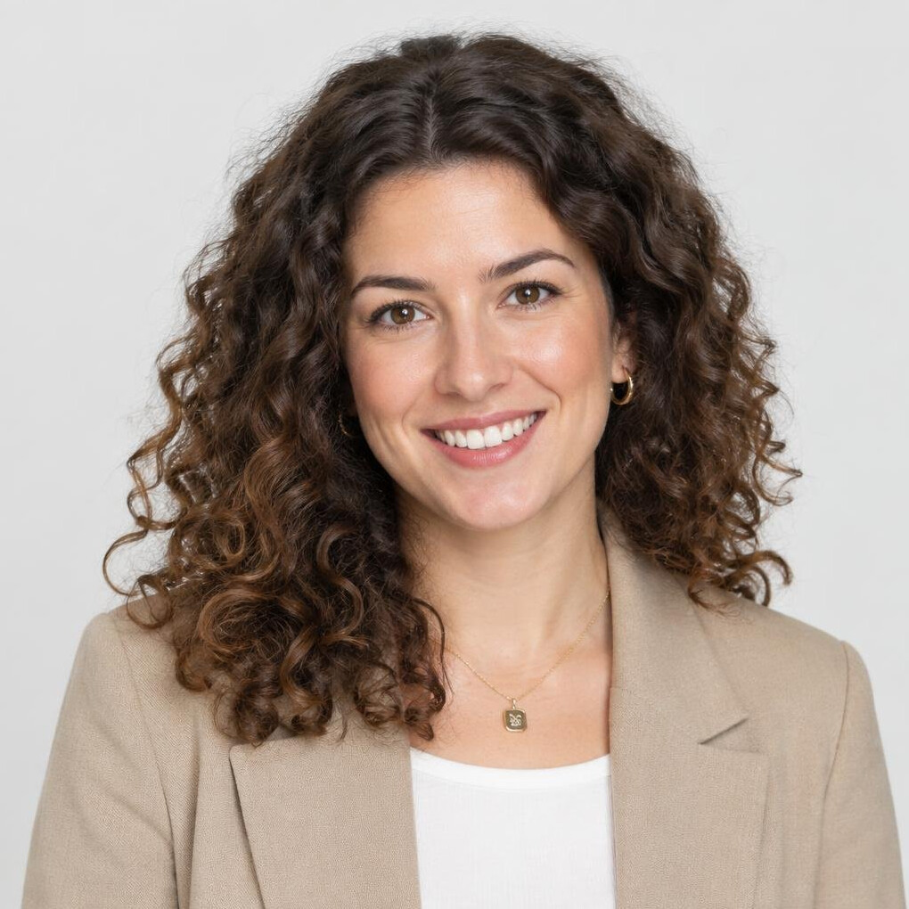 Studio portrait of a woman with curly hair smiling